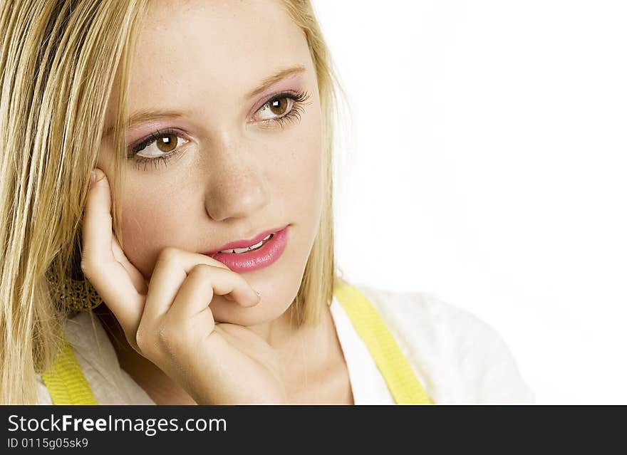 A portrait of a beautiful blond Caucasian young girl (15-24) looking at the copy space on white background, model release. A portrait of a beautiful blond Caucasian young girl (15-24) looking at the copy space on white background, model release.