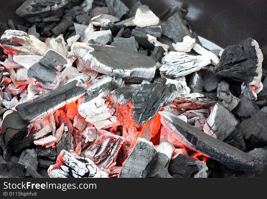 Glowing coals on a grill.