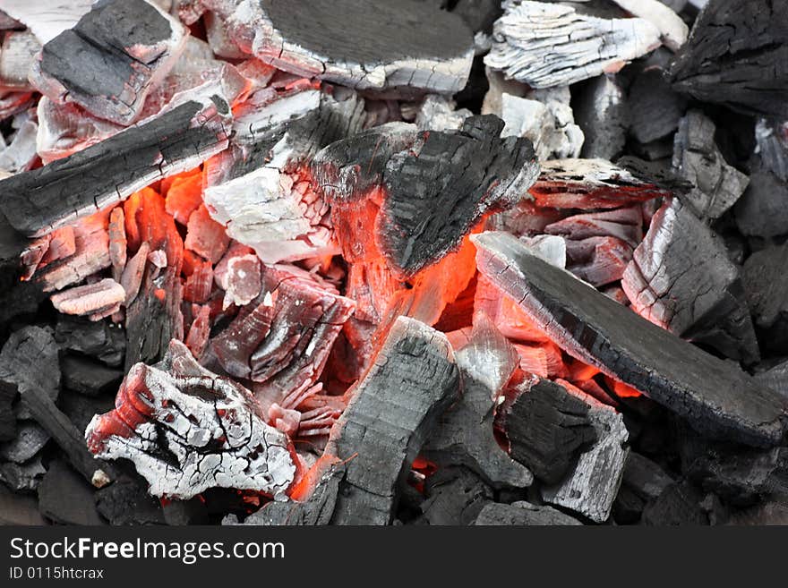 Glowing coals on a grill.