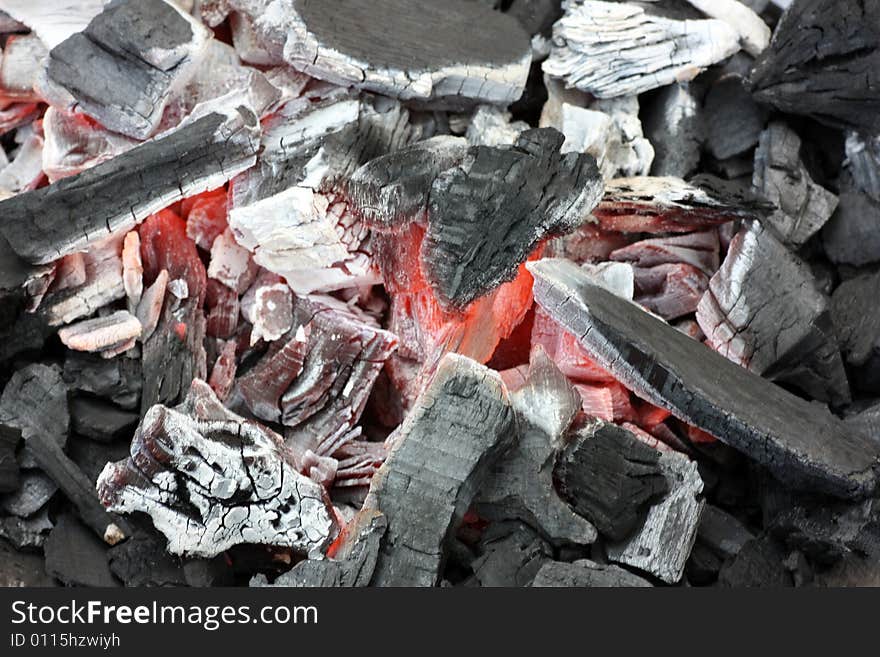 Glowing coals on a grill.