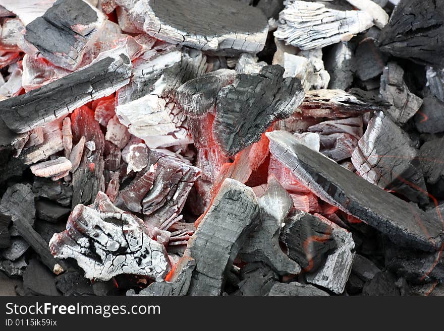 Glowing coals on a grill.