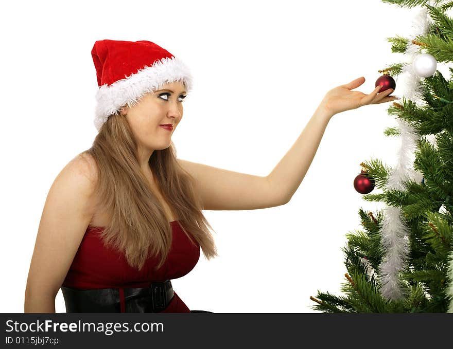 Mrs santa looking at red christmas ornament hanging on christmas tree. Mrs santa looking at red christmas ornament hanging on christmas tree