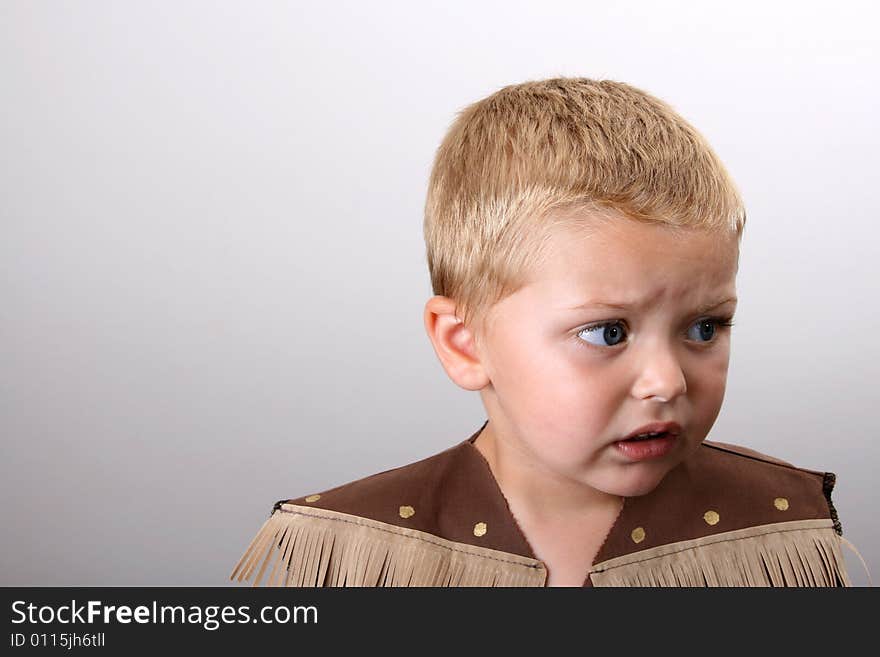 Toddler wearing a cowboy shirt with brown fringing