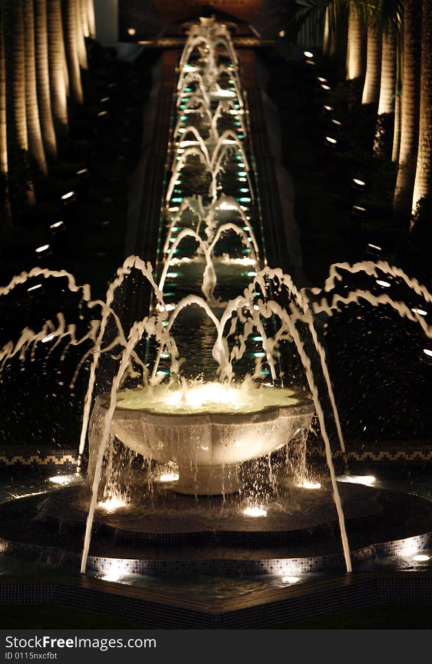 A decorated water fountain at night.