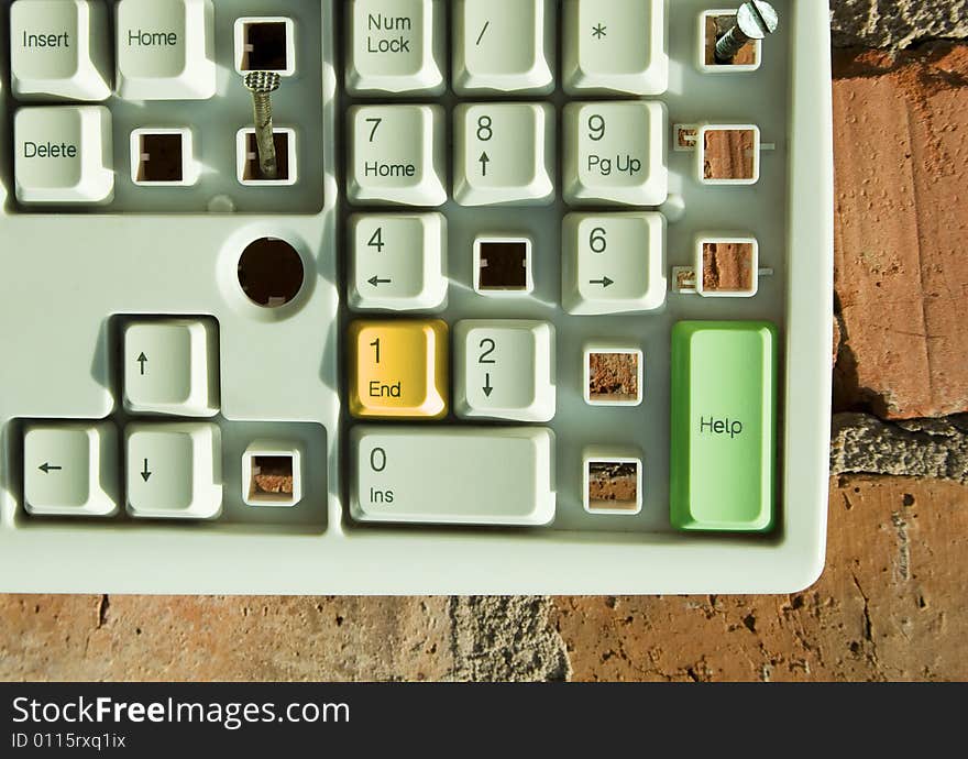 Disassembled keyboard with color button on the brick wall