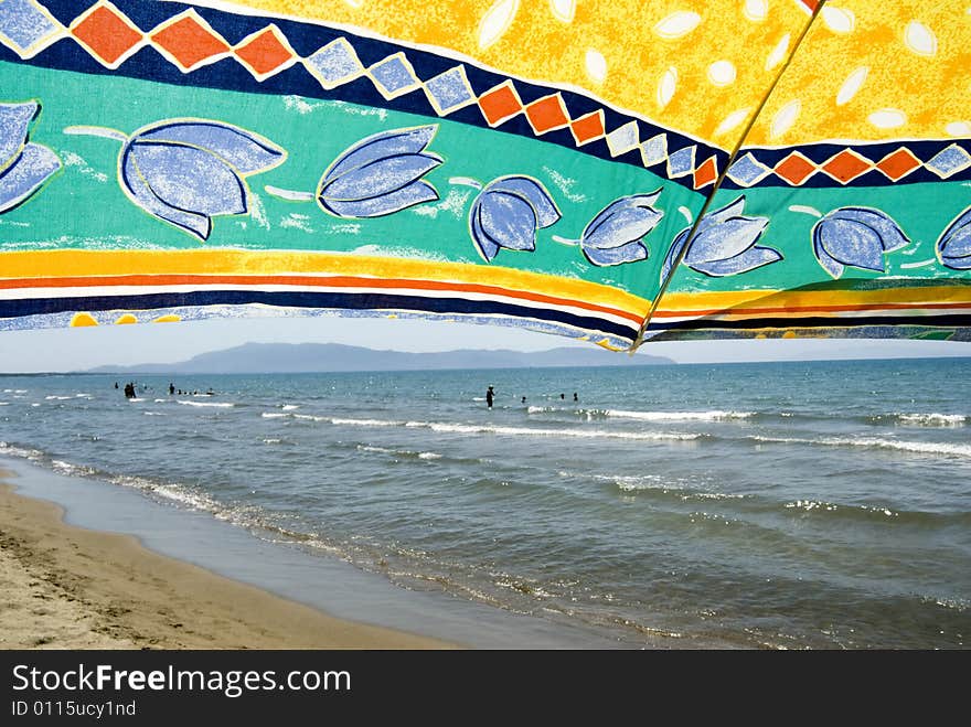 Sea scene seen from under a beach umbrella. Sea scene seen from under a beach umbrella