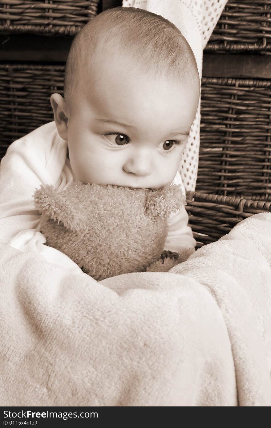 Six month old baby sitting infront of wooden drawers. Six month old baby sitting infront of wooden drawers