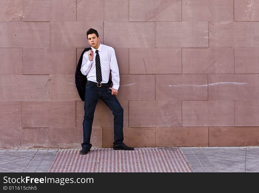 Businessman posing on wall