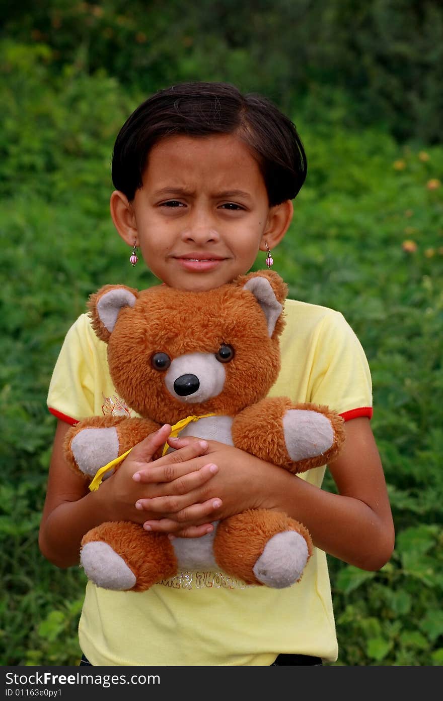 A girl with her favourite teddy bear. A girl with her favourite teddy bear.