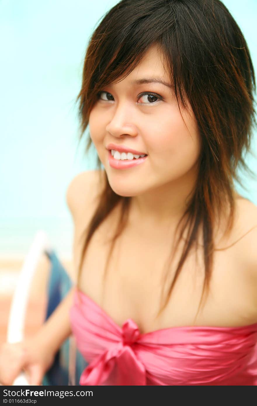 Beautiful young girl sit by pool side, showing happy expression. Beautiful young girl sit by pool side, showing happy expression