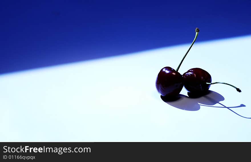 Photo of cherry on white and blue background