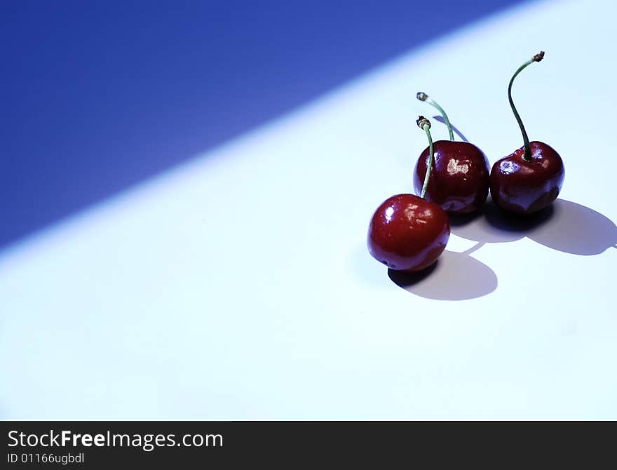 Photo of cherry on white and blue background