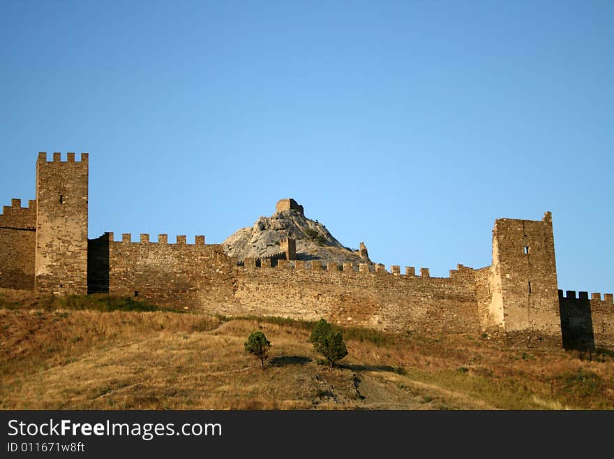 Ancient fortress on the rock on blue sky background