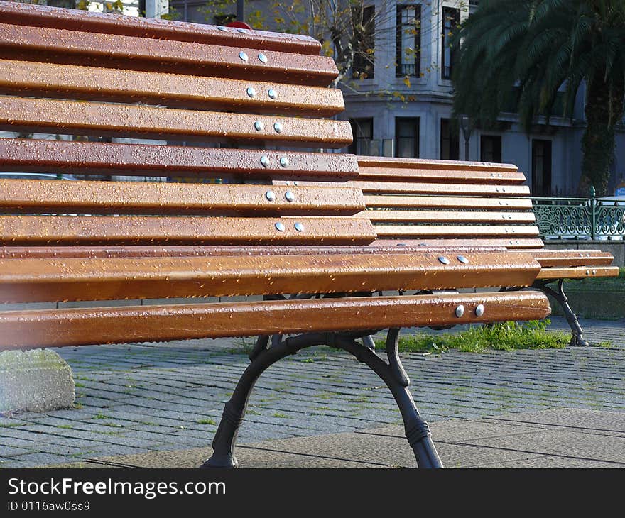 Two benches with dew in the city