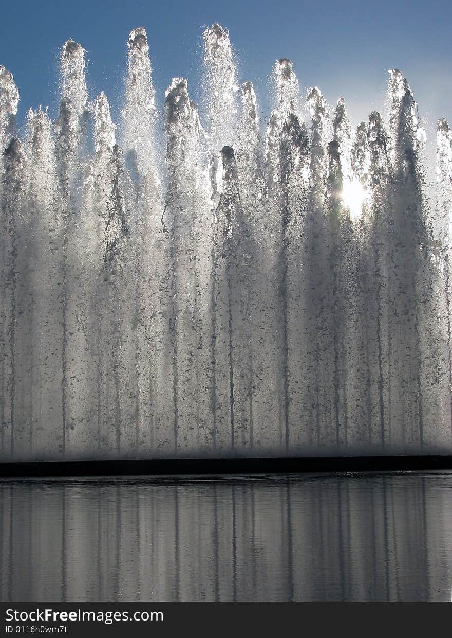 The sun through a fountain and reflecting pool. The sun through a fountain and reflecting pool.