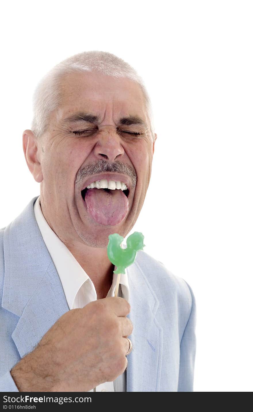 Senior man lick the green sweet candy. Senior man lick the green sweet candy