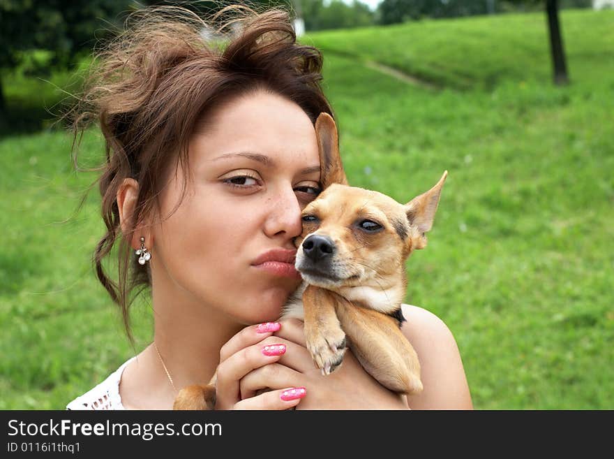 Girl with little dog (toy terrier) in the park. Girl with little dog (toy terrier) in the park