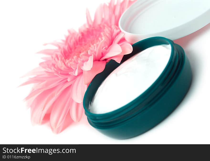 Moisturizing cream with pink gerbera close up