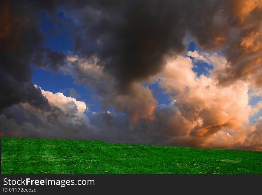 Composite picture of a hill in a park and sky taken the day before. Composite picture of a hill in a park and sky taken the day before.