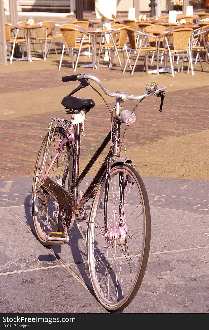 A bicycle parked at a compass rose