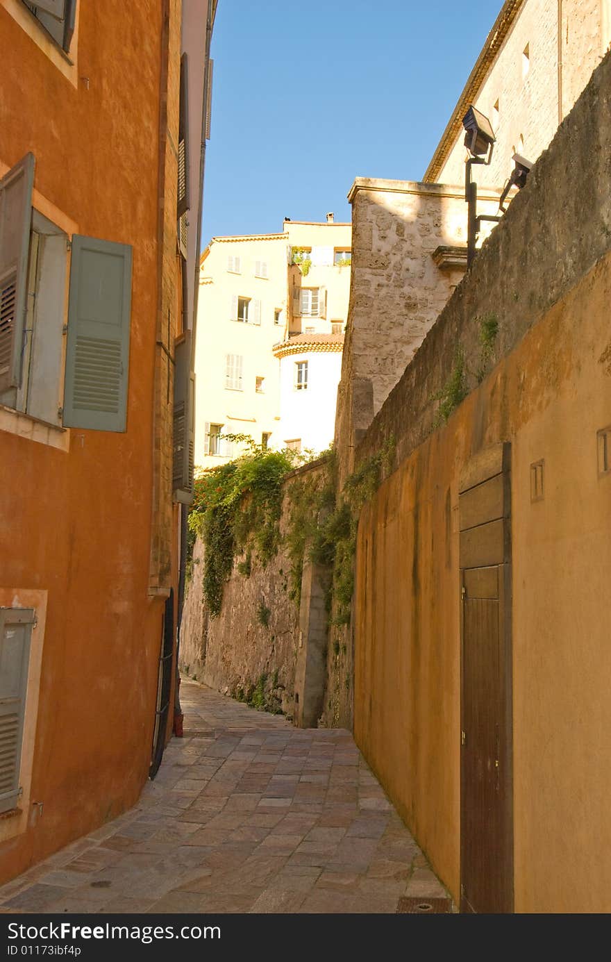 Colorful alley with stone walls and ancient pavement. Colorful alley with stone walls and ancient pavement