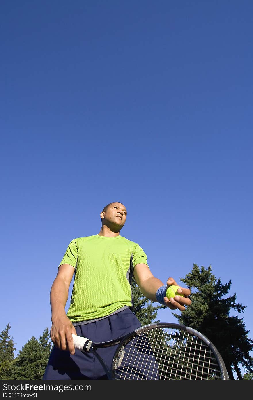 Man on Tennis Court Holding Racket