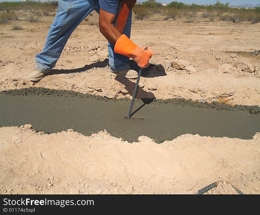 Man Digging Dirt on Excavation Site - Horizontal