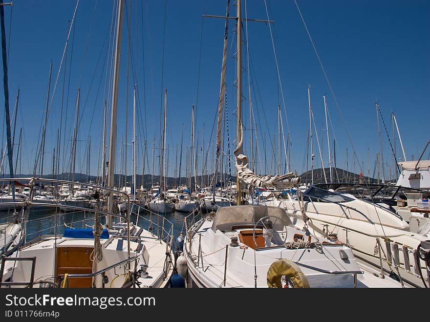 Luxury sailing-yachts at anchor illuminated by the sun