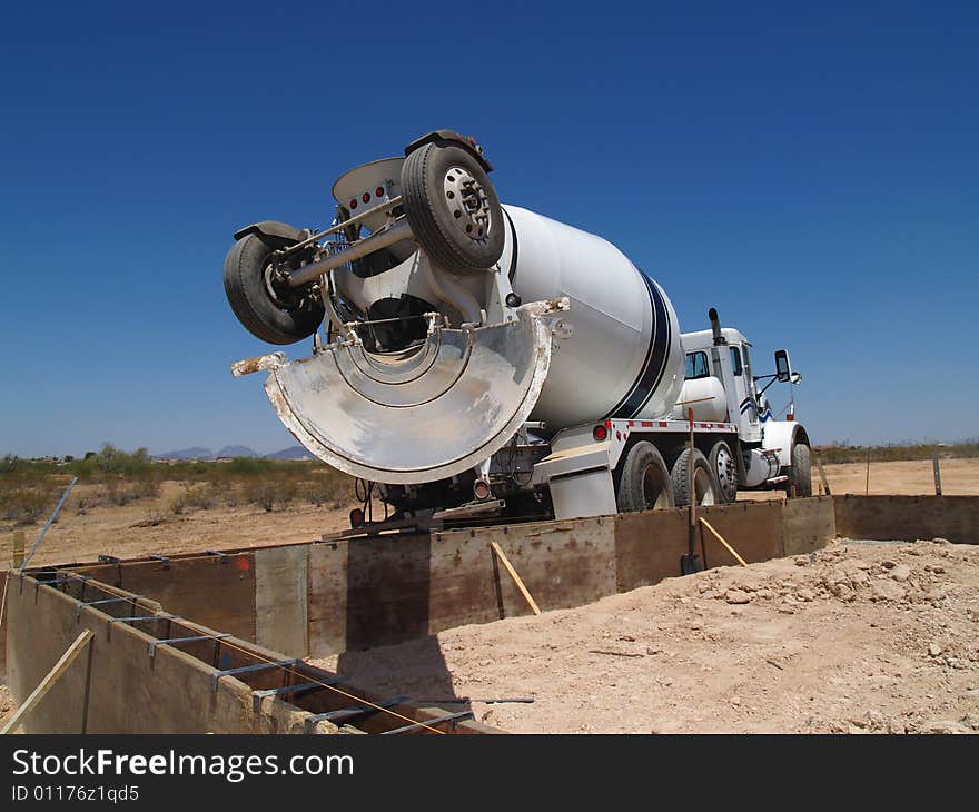 A cement mixing truck is parked in the desert. Horizontally framed shot. A cement mixing truck is parked in the desert. Horizontally framed shot.