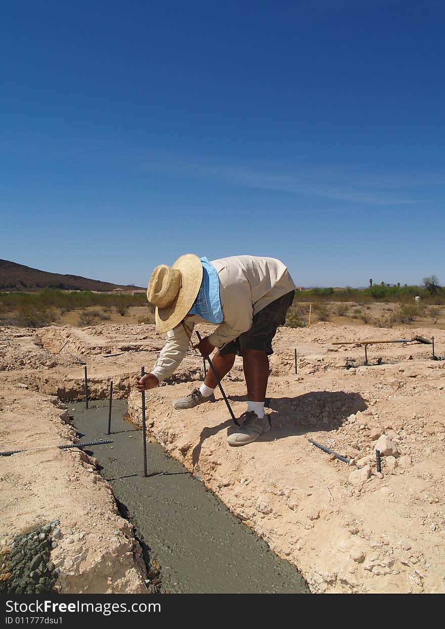 Man Digging on Excavation Site - Vertical