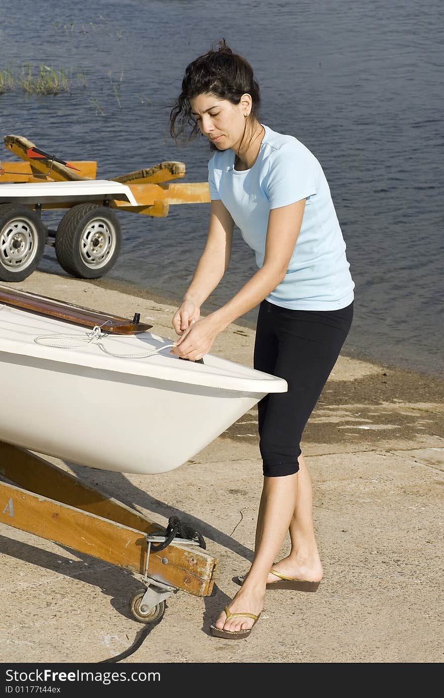 Woman Fixing Something on Boat - Vertical