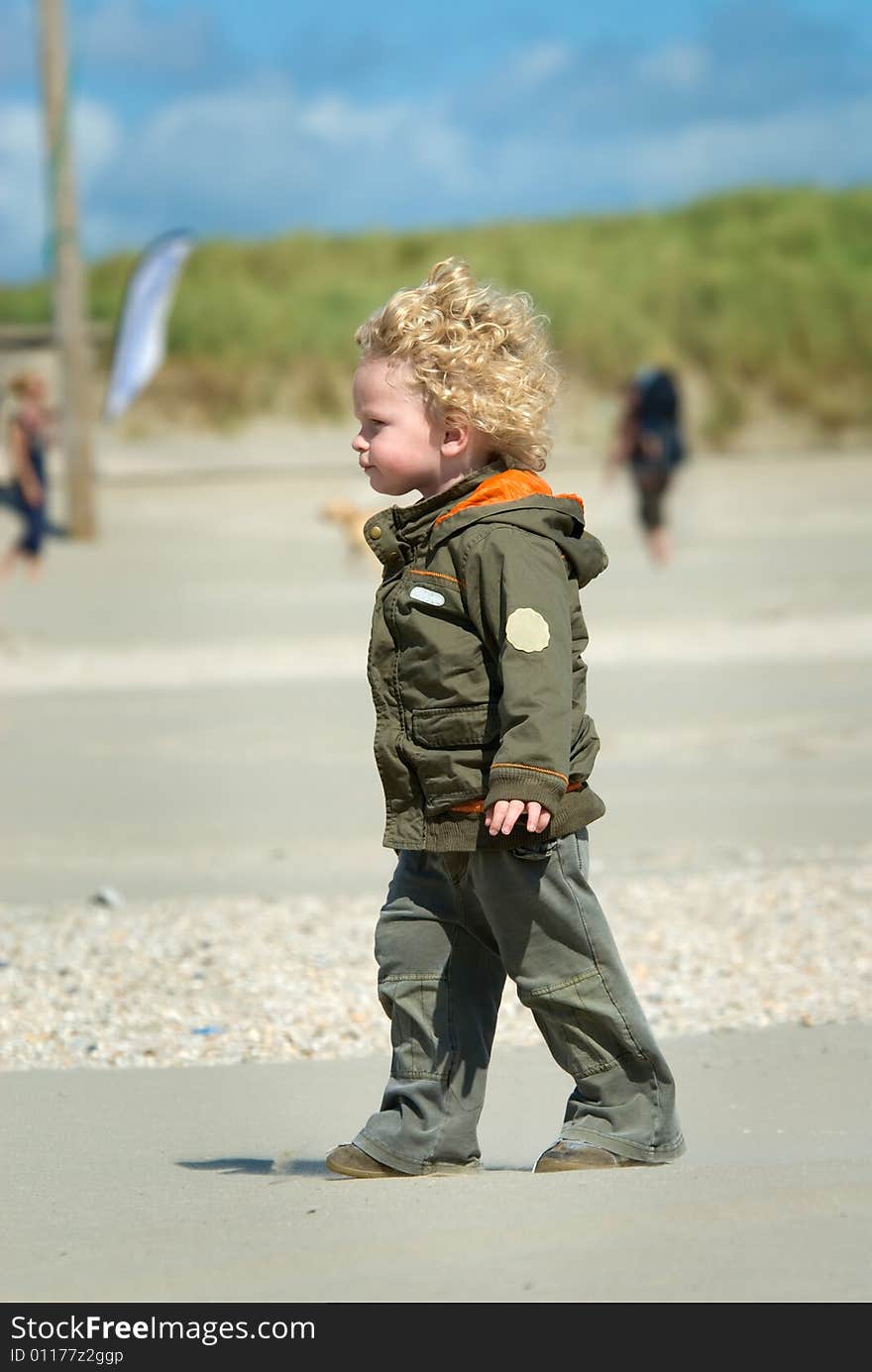 Boy Walking On The Beach