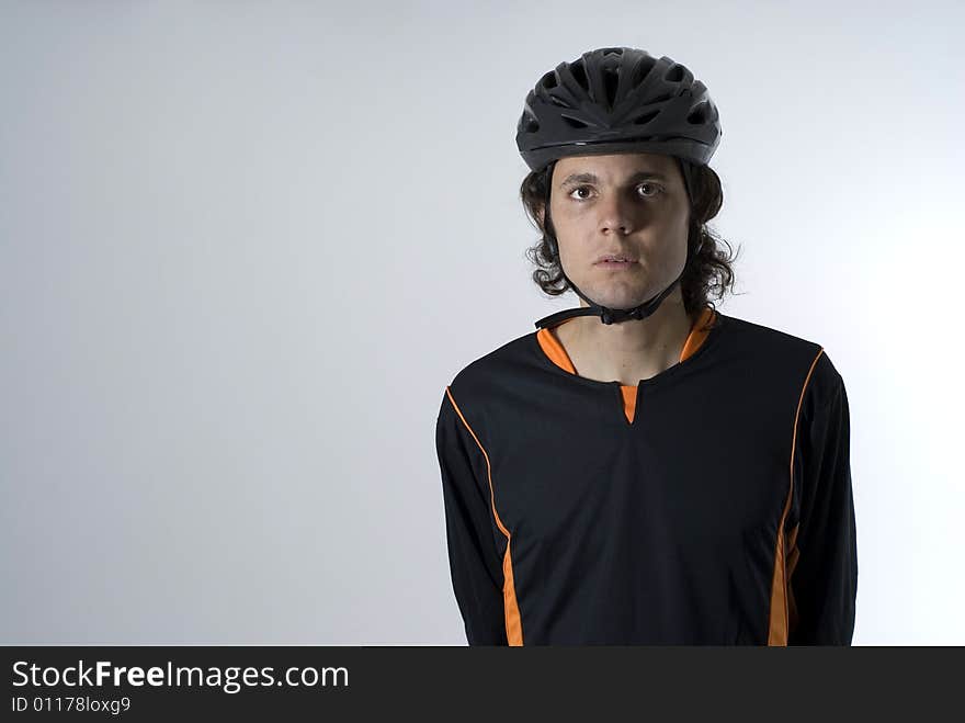 Man wearing a helmet has a serious expression on his face. Horizontally framed photograph. Man wearing a helmet has a serious expression on his face. Horizontally framed photograph