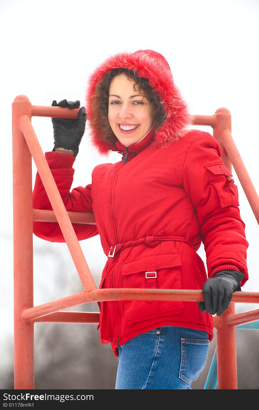 A pretty woman on metallic ladder in winter