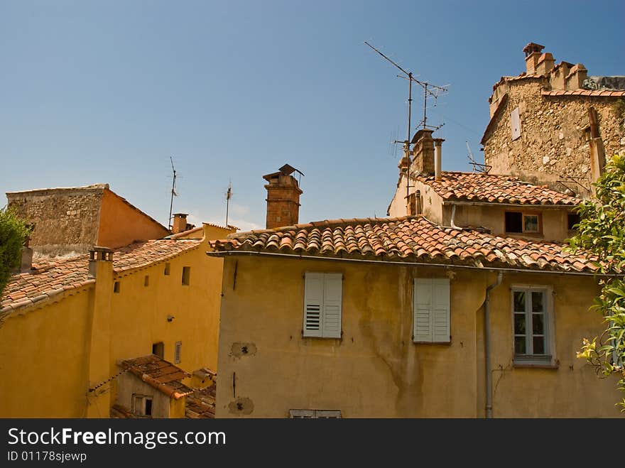 Old houses illuminated by the sun in front of the blue sky