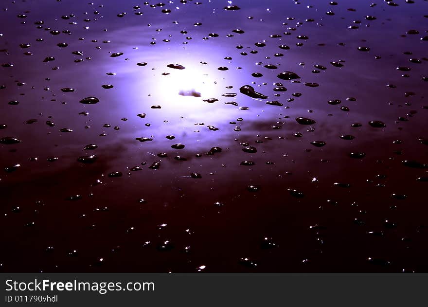 Sky reflected in a tinted glass, while still wet after the rain. Sky reflected in a tinted glass, while still wet after the rain