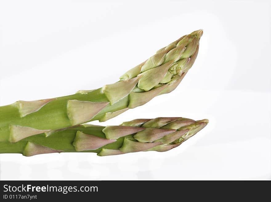 Two asparagus spears isolated over white backgrond