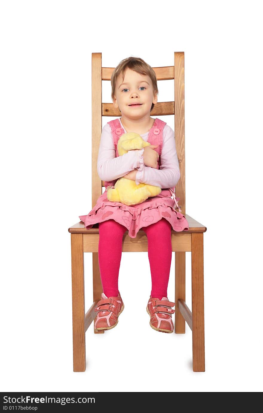 Little girl with toy sitting on stool