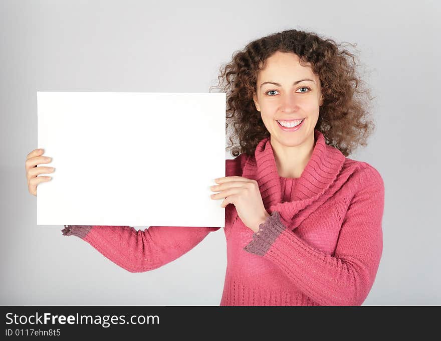 Young woman keeps white sheet of paper