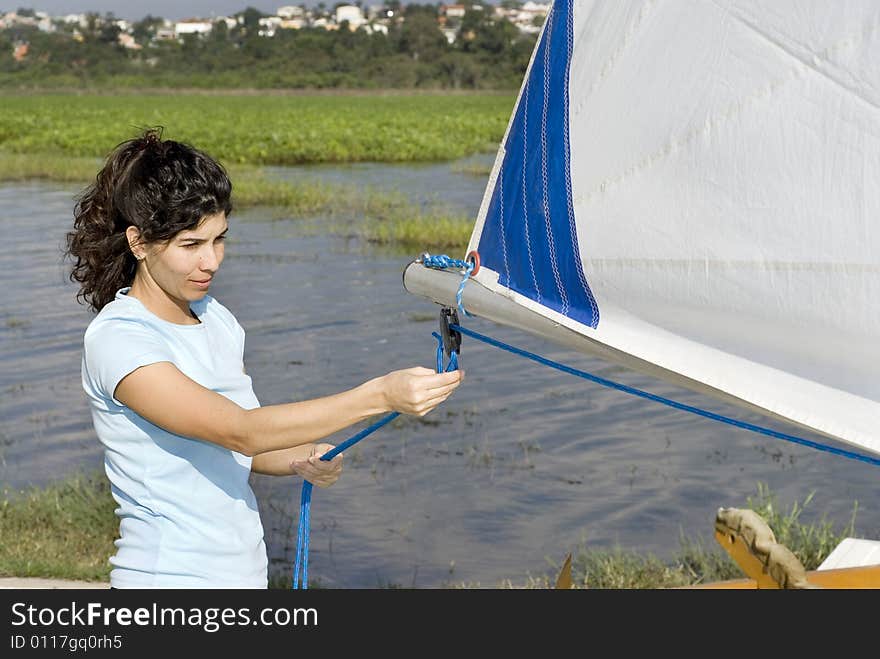 Woman Fixing Ropes on Sailboat - Horizontal