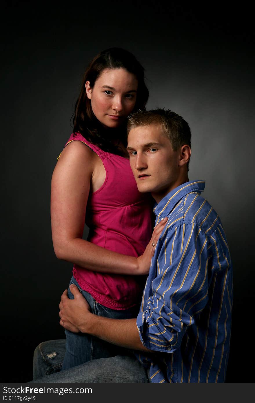 Passionate urban couple together against a dark background