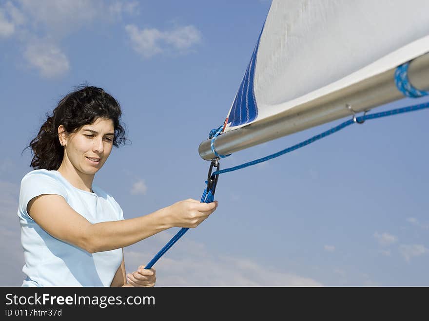 Woman Fixing Sail on Sailboat - Horizontal