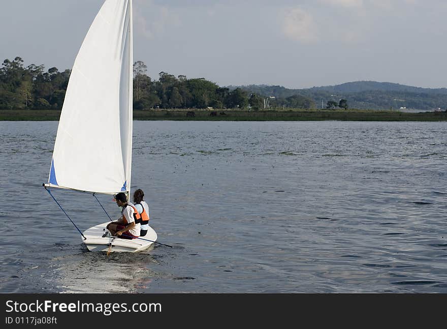 Man And Woman Sitting On Sailboat - Horizontal