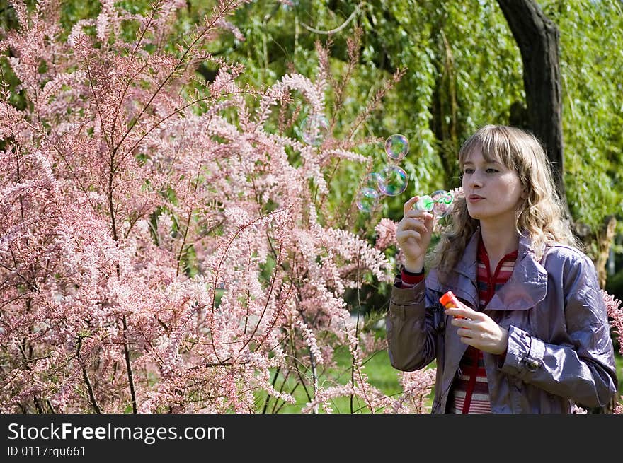 Girl blowing bubble in the park