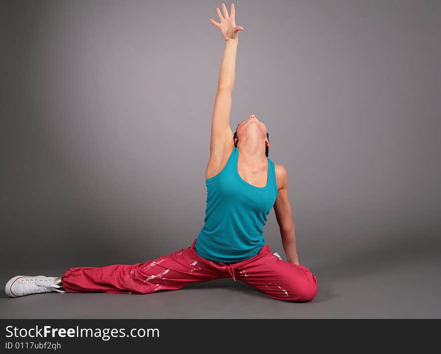 Woman dances on a grey