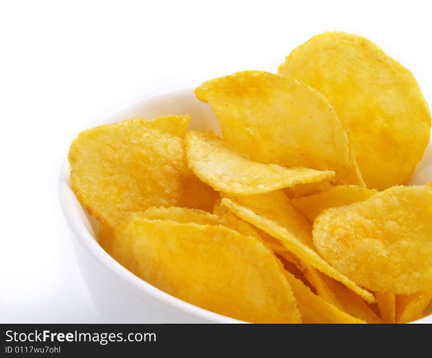 Yummy potato chips in white bowl. Yummy potato chips in white bowl