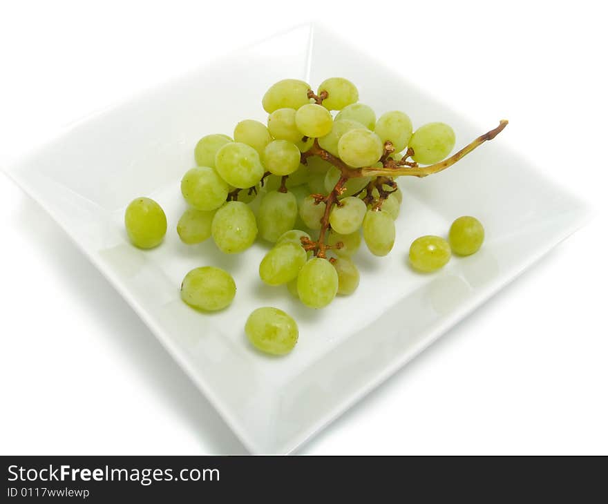 Fresh bunch of green grapes in white bowl and isolated on white background. Fresh bunch of green grapes in white bowl and isolated on white background