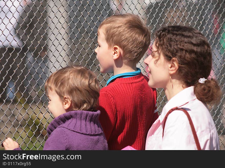 Mother and children look through  lattice