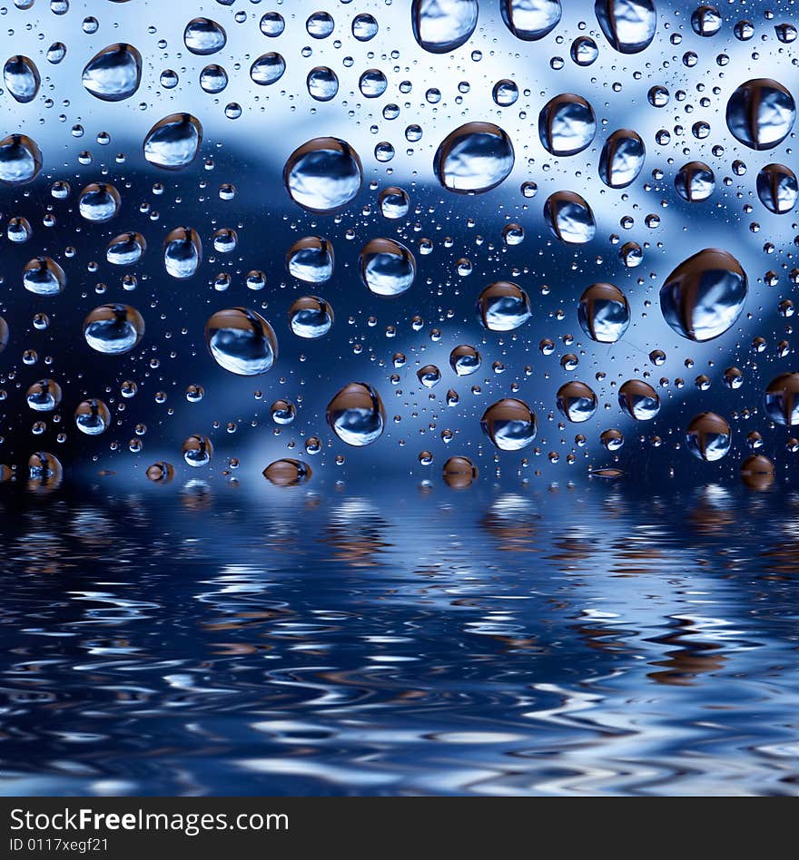 Blue droplets reflected in the water