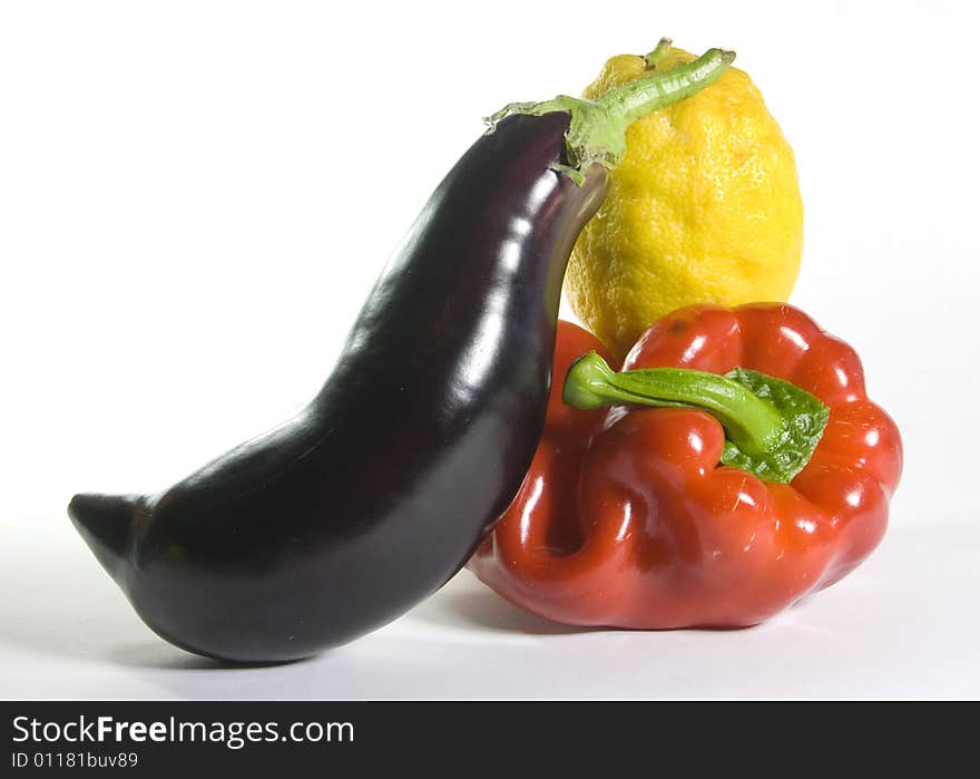 Eggplant, red pepper and lemon isolated on white background. Eggplant, red pepper and lemon isolated on white background